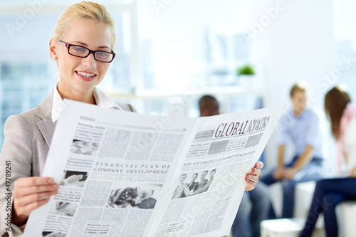 Photo: Woman with newspaper Woman with newspaper
