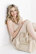 Photo: portrait of sitting woman wearing summer clothes with a handbag portrait of sitting woman wearing summer clothes with a handbag