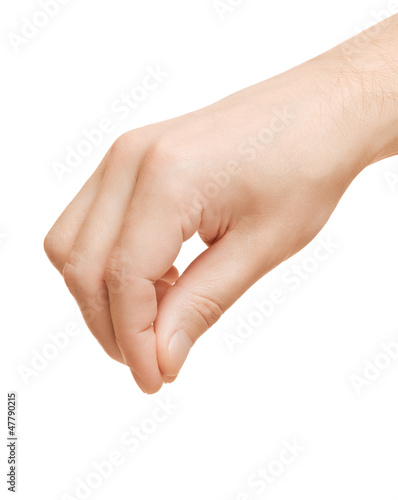 Photo: Hand adds in food salt and spices. Or holding some object. Hand adds in food salt and spices. Or holding some object.