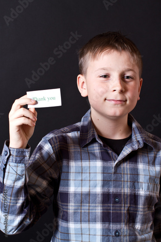 Photo: boy shows a card with gratitude boy shows a card with gratitude