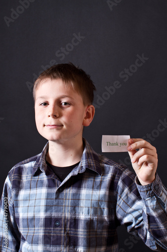 Photo: boy shows a card with gratitude boy shows a card with gratitude
