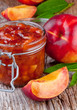 nectarine, peach jam on wood background