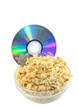 Bowl full of caramel popcorn with DVD disk .