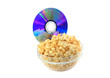 Bowl full of caramel popcorn with DVD disk .