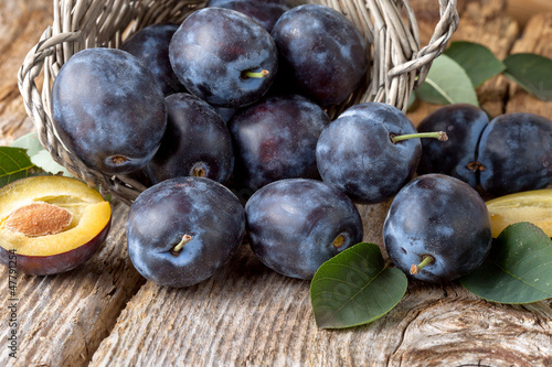 Photo: group of fresh plums on wood background group of fresh plums on wood background