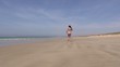 happy bikini woman arrives at the beach