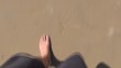 man feet walking on beach 60