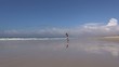 woman comes jogging at beach