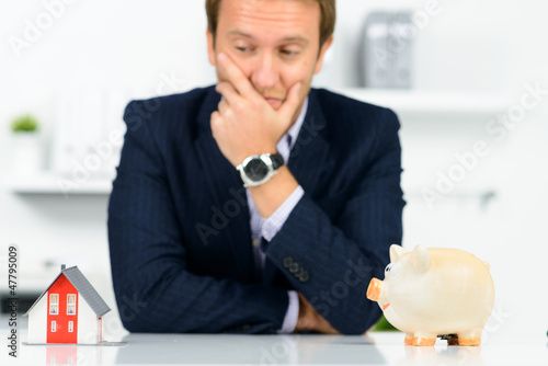 Photo: mann macht sich gedanken über einen hauskauf mann macht sich gedanken über einen hauskauf
