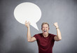 Photo: Successful man holding empty speech balloon. Successful man holding empty speech balloon.