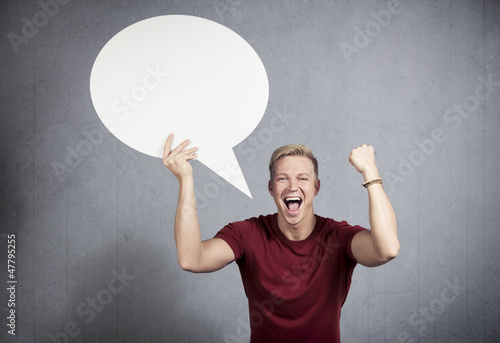 Photo: Successful man holding empty speech balloon. Successful man holding empty speech balloon.