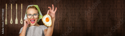 Photo: Happy funny woman cook with fried egg - web banner crop concept Happy funny woman cook with fried egg - web banner crop concept