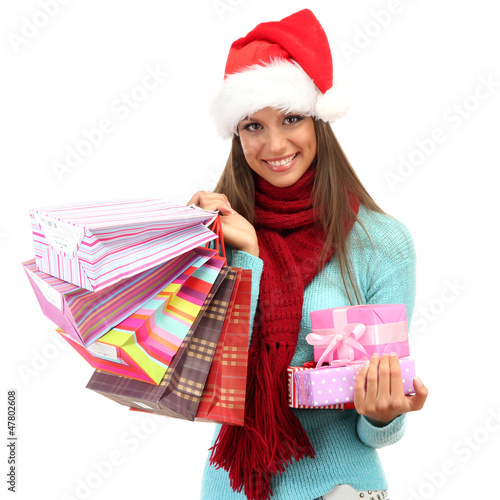 Photo: beautiful young woman with shopping bags and gifts, isolated beautiful young woman with shopping bags and gifts, isolated