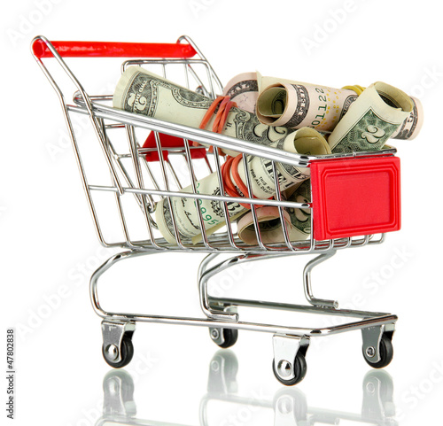 Photo: shopping trolley with dollars, isolated on white shopping trolley with dollars, isolated on white