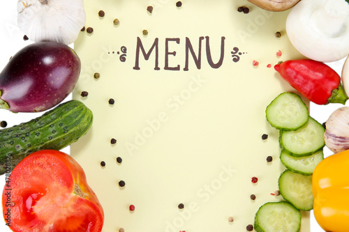 Photo: Menu surrounded by products and vegetables on yellow paper Menu surrounded by products and vegetables on yellow paper