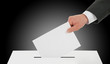 Man hand down ballot in the ballot box