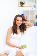 Young woman having cup of tea at home