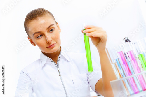 Photo: Young female scientist working in laboratory Young female scientist working in laboratory