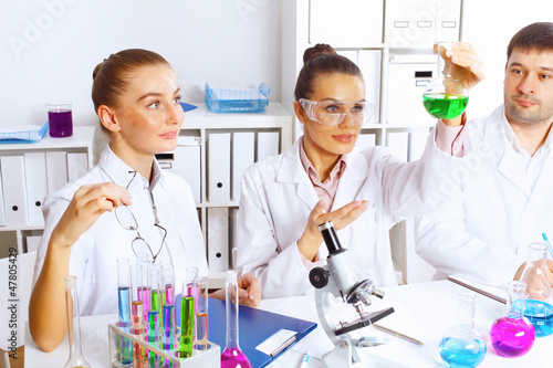 Photo: Team of scientists working in laboratory Team of scientists working in laboratory