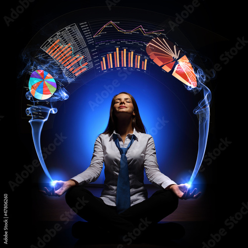 Photo: Business woman with financial symbols around Business woman with financial symbols around