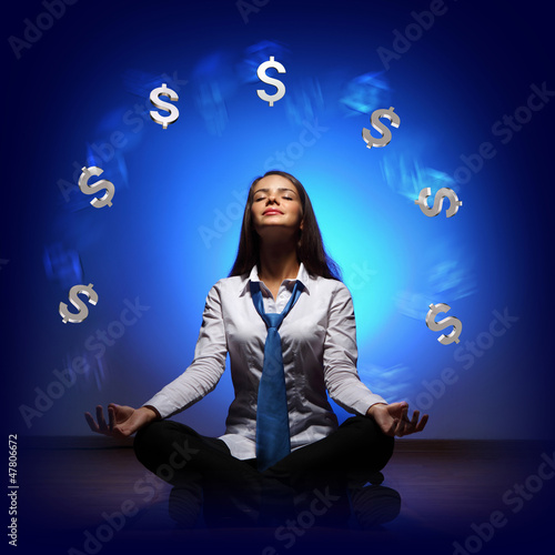 Photo: Business woman with financial symbols around Business woman with financial symbols around