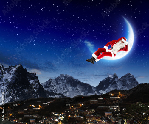 Photo: photo of santa claus sitting on the moon photo of santa claus sitting on the moon