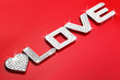 Word LOVE in silver metal with diamond