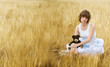 The sad girl in the field with a bear in a hand