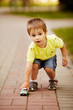 little boy plays with toy car