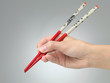 Foto: hand with pair of chopsticks hand with pair of chopsticks