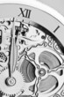 Photo: black and white close view of watch hands and mechanism black and white close view of watch hands and mechanism