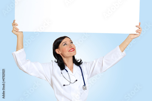 Photo: Young female doctor with a banner Young female doctor with a banner