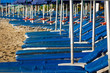 Roe of striped deck chairs on the beach
