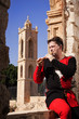 Man in a medieval suit plays a flute