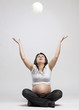 Pregnant woman playing with balloons