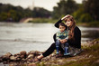 mother with son sitting on coast