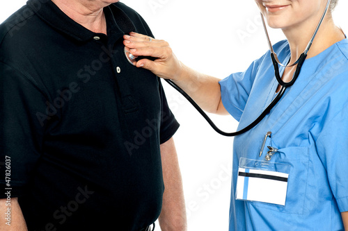 Photo: Cropped image of doctor examining a patient Cropped image of doctor examining a patient