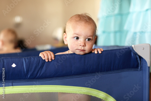 Photo: Pensive baby at playpen Pensive baby at playpen