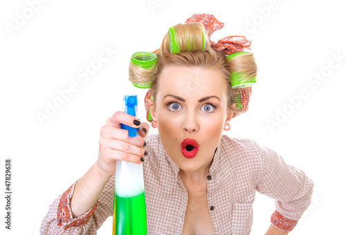 Photo: Surprised housewife / woman spraying the cleaner Surprised housewife / woman spraying the cleaner