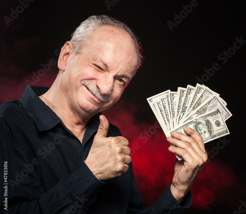 Photo: old man with dollar bills old man with dollar bills