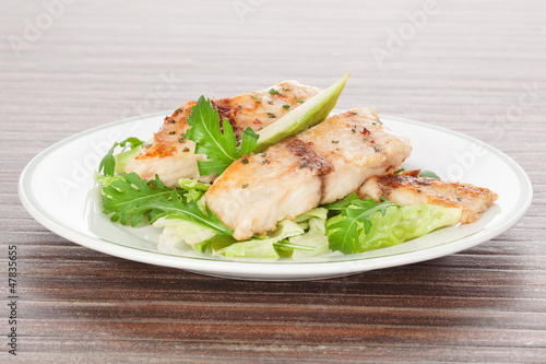 Photo: Grilled fish and fresh salad. Grilled fish and fresh salad.