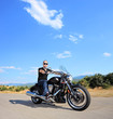 A biker riding a customized motorcycle on an open road