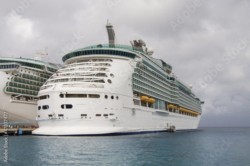 Photo: Two Luxury Cruise Ships Under Cloudy Sky Two Luxury Cruise Ships Under Cloudy Sky