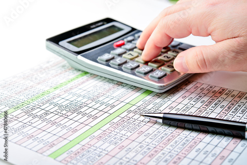 Photo: Tax forms, spread sheet with pen and calculator. Tax forms, spread sheet with pen and calculator.