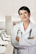 Young doctor in white uniform. Woman with lab coat and stethosco