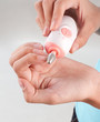 Photo: woman polishing her fingernails by polish nail machine woman polishing her fingernails by polish nail machine