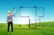 Photo: Architect drawing house blueprints on green field and blue sky Architect drawing house blueprints on green field and blue sky