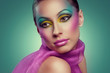 Woman face with creative many-coloured makeup