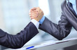 Two businessmen press hands each