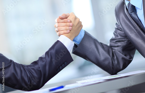 Photo: Two businessmen press hands each Two businessmen press hands each